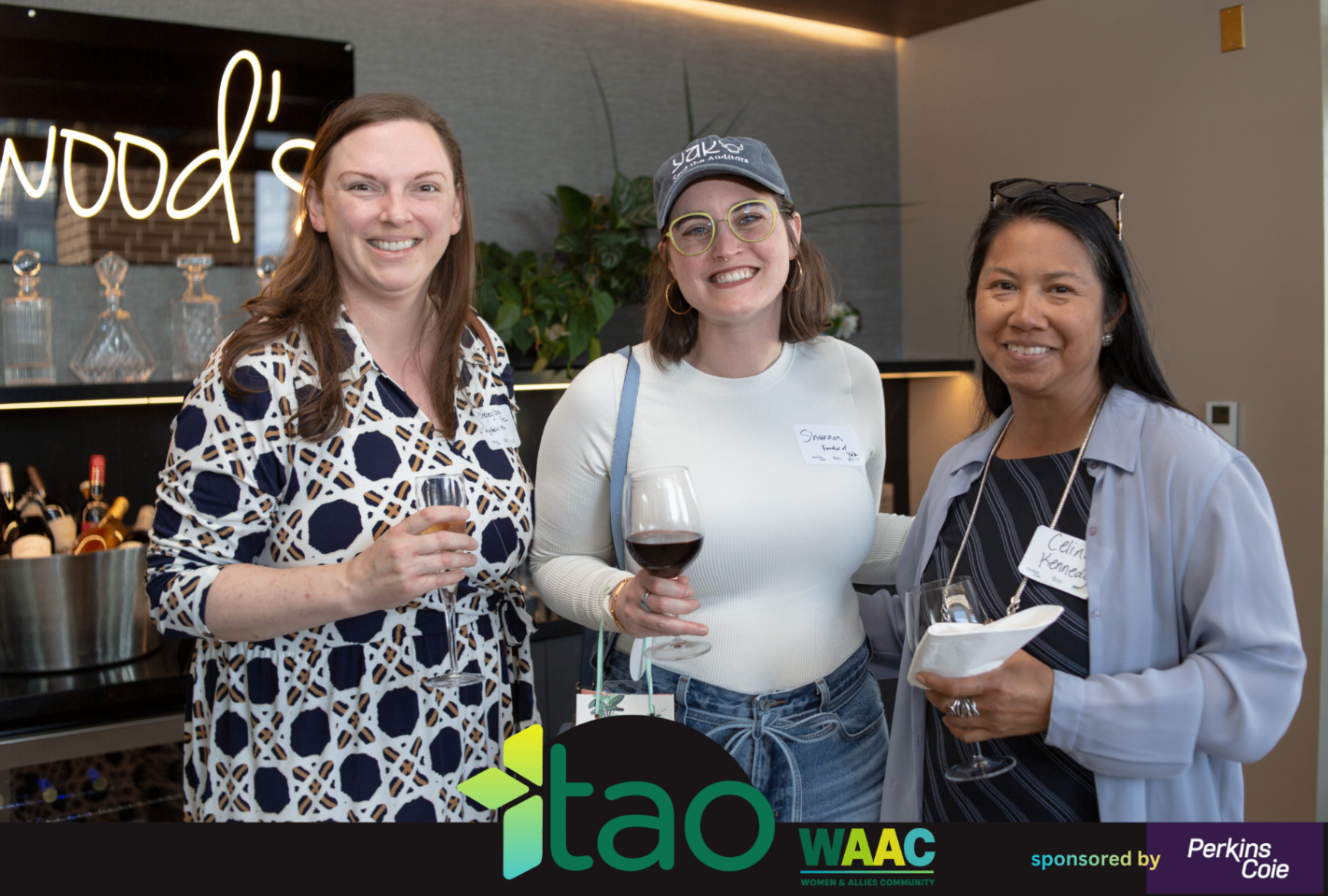 Three WAAC attendees holding drinks and smiling during networking.