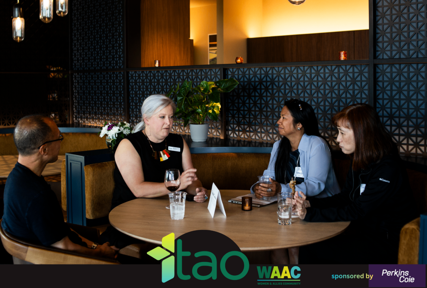 Small group conversation around a round table during the WAAC event.