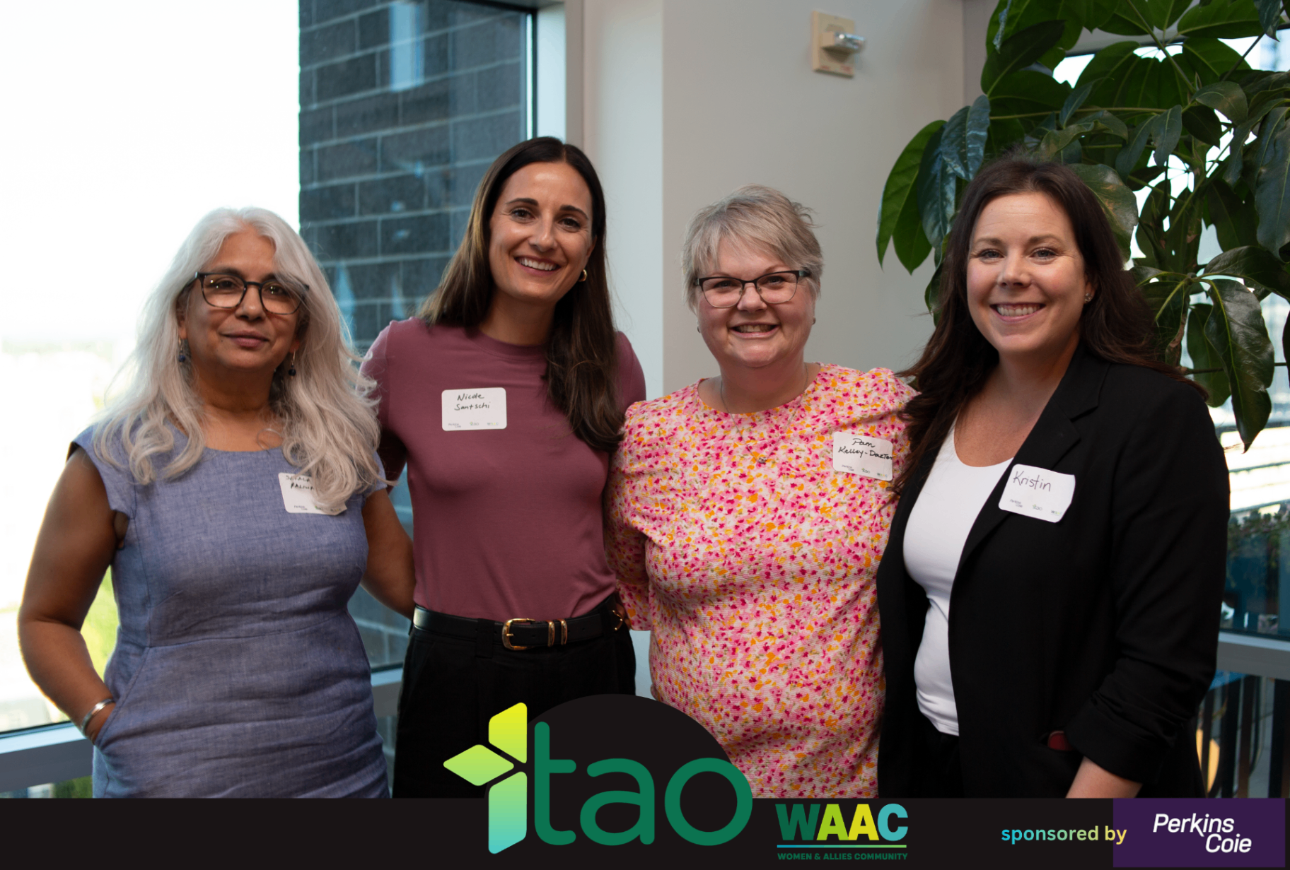 Four WAAC attendees standing together and smiling during the event.
